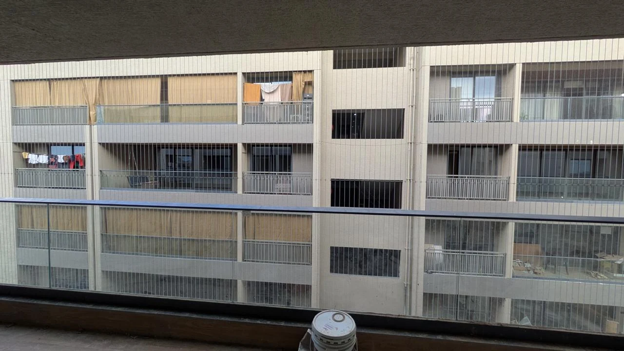 Invisible grill cables protecting a balcony with an open view