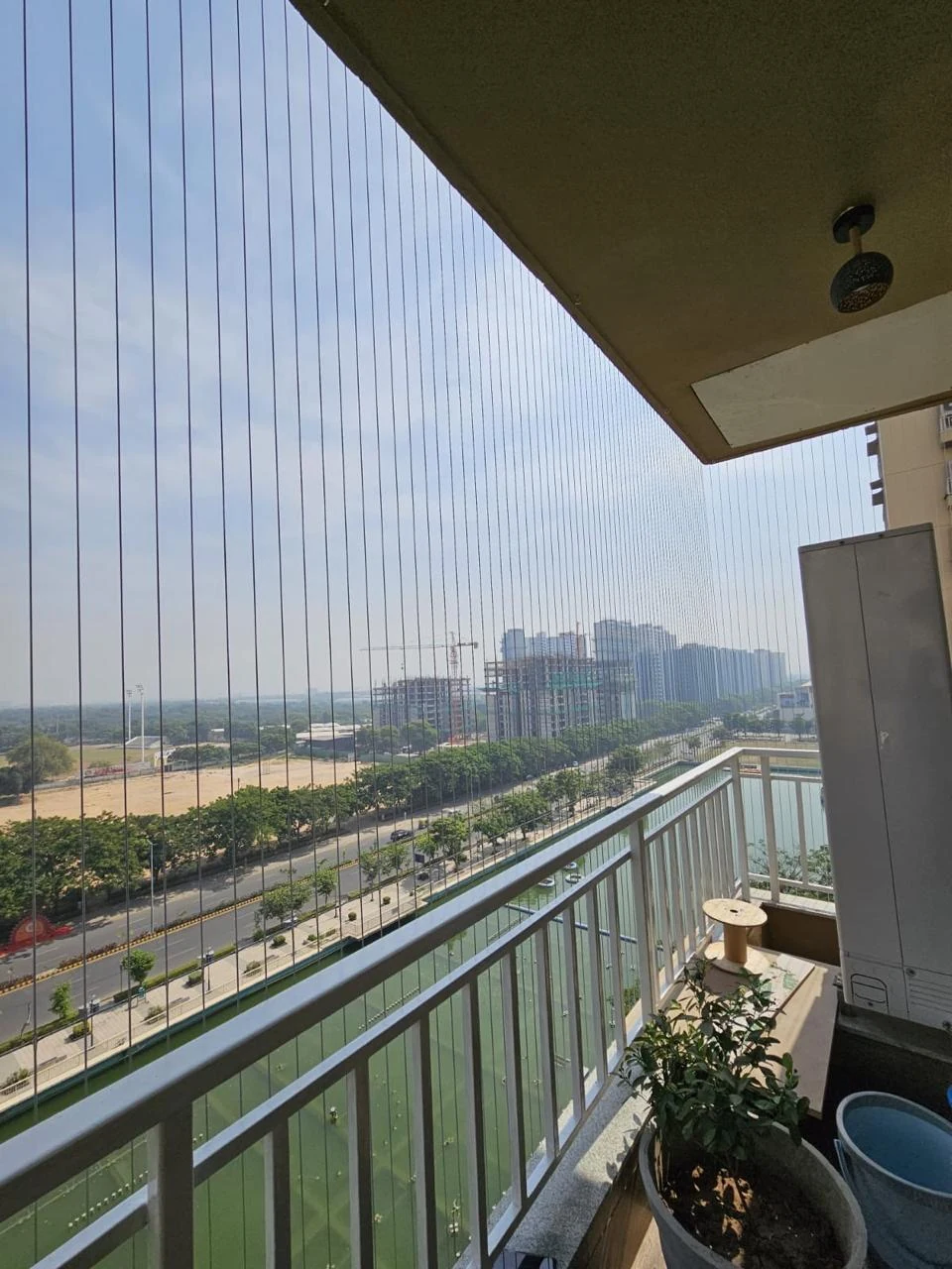 Invisible grill installation on an elevated balcony
